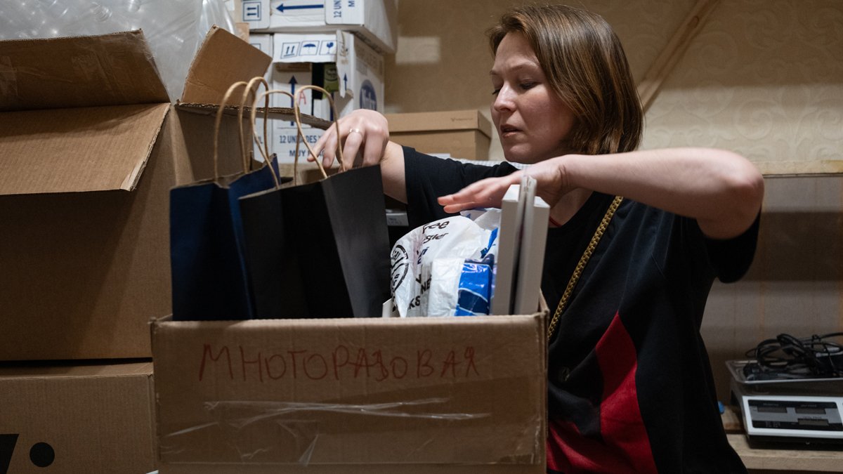 Маргарита разбирает коробки с гуманитарной помощью. Фото: Дмитрий Вепрев