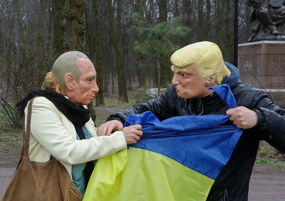Protesters wearing masks of Putin and Trump fight over a Ukrainian flag during a rally in support of Ukraine outside the US Embassy in Kyiv, 15 March 2025. Photo: EPA-EFE / SERGEY DOLZHENKO